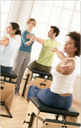 Pilates instructor demonstrating proper form and technique