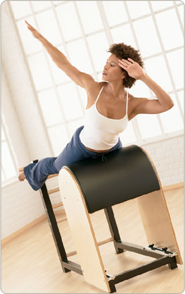 Pilates instructor demonstrating proper form and technique