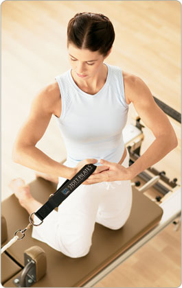 Pilates instructor demonstrating proper form and technique